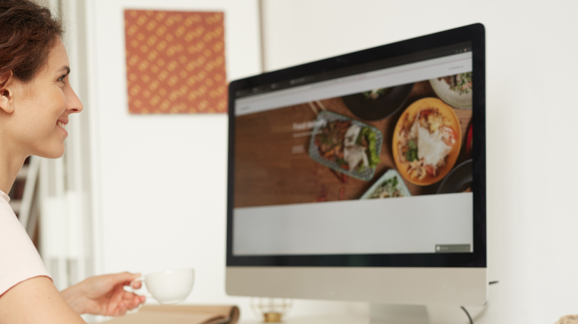 woman smiling while checking and building a scalable website design in dallas on her computer woman smiling while checking and building a scalable website design in dallas on her computer