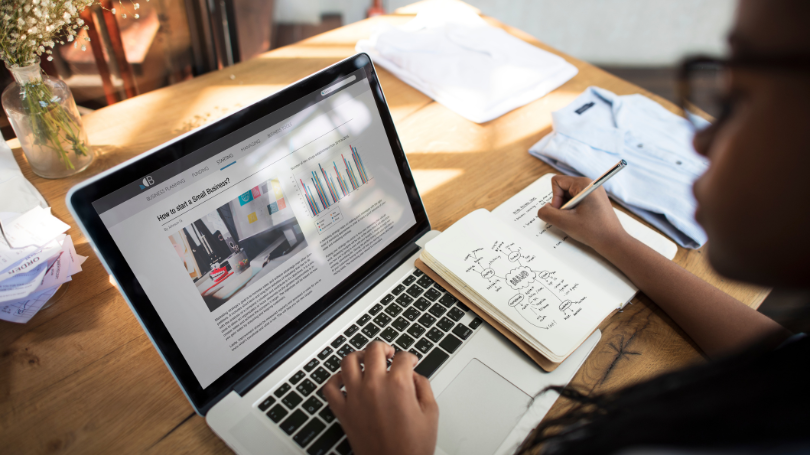 woman taking notes while checking her computer about scaling website for future growth in dallas woman taking notes while checking her computer about scaling website for future growth in dallas