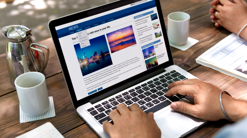 a man checking a news website on his computer a man checking a news website on his computer