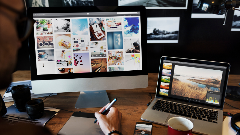 a man designing a website using his laptop and computer a man designing a website using his laptop and computer