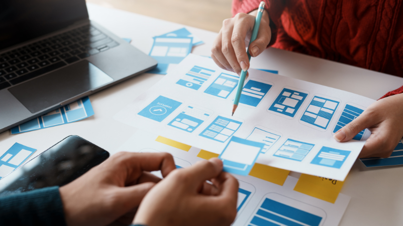 a team discussing the web design of their project a team discussing the web design of their project