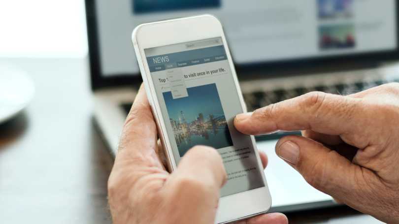  man cheacking a mobile web design example in dallas on his phone