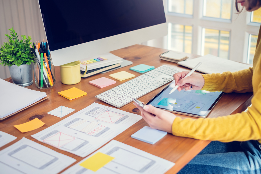 a woman planning a website design accessible for mobile version a woman planning a website design accessible for mobile version