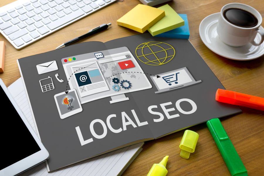An open book on a desk with the words "LOCAL SEO" and related marketing icons on its pages. An open book on a desk with the words "LOCAL SEO" and related marketing icons on its pages.